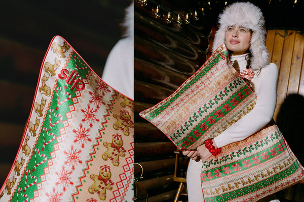 A split image showing a close-up of a Christmas-themed silk pillowcase on the left, and a model wearing a white fur-trimmed hat holding the same pillow on the right. The pillow features a festive pattern of gingerbread cookies, snowflakes, and holly in green, red, and beige.